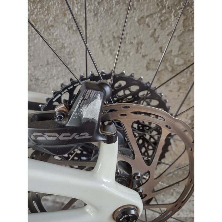 2024 Santa Cruz Bronson 4.1 C MX S-Kit — Mixed Wheels, gloss chalk white, brake caliper blemish view.