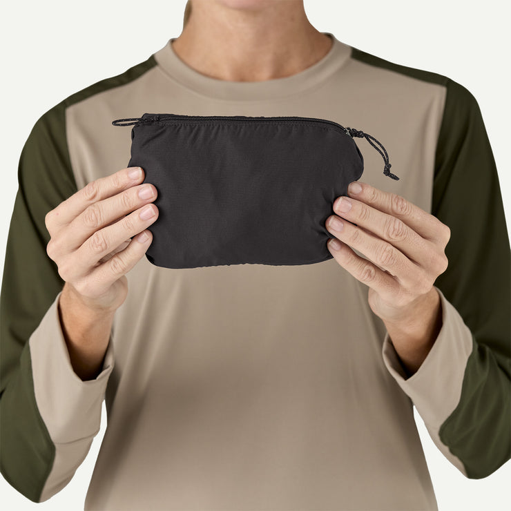 Patagonia Women's Trail Craft Vest, black, packed view held by model.